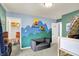 Comfortable bedroom featuring themed wall art, carpeted floors, and natural light from a nearby window at 442 Mozart Dr, Greenfield, IN 46140
