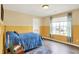 Bedroom with hard wood floors, area rug, blue bed, and a window at 442 Mozart Dr, Greenfield, IN 46140