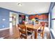Bright dining area with hardwood floors, a wooden table set, and views of the kitchen at 442 Mozart Dr, Greenfield, IN 46140