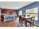 Cozy dining area features a wooden table, padded chairs, and natural light from the window at 442 Mozart Dr, Greenfield, IN 46140