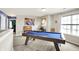 Open game room featuring a pool table, natural light, and comfortable seating at 442 Mozart Dr, Greenfield, IN 46140