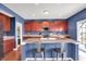 Well-lit kitchen features an island with bar seating, custom cabinets, and stainless steel appliances at 442 Mozart Dr, Greenfield, IN 46140