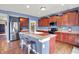 Modern kitchen with stainless steel appliances, an island with seating, and ample cabinet space at 442 Mozart Dr, Greenfield, IN 46140