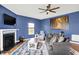 Inviting living room features a fireplace, neutral-toned sofa, and a nature-themed art piece at 442 Mozart Dr, Greenfield, IN 46140