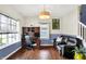 Comfortable living room featuring a workstation, hardwood floors, and large windows at 442 Mozart Dr, Greenfield, IN 46140