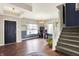 Open-concept living room showcasing beautiful hardwood floors, a staircase, and ample natural light at 442 Mozart Dr, Greenfield, IN 46140