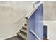 Carpeted staircase with white railings and accent wall, enhancing the home's architectural details at 442 Mozart Dr, Greenfield, IN 46140
