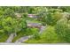 Aerial view of a red brick house in a neighborhood, surrounded by mature trees and green lawns at 4614 Thornleigh Dr, Indianapolis, IN 46226