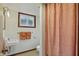 Cozy bathroom with vintage style sink, peach towels and accent details, and light from the window at 4614 Thornleigh Dr, Indianapolis, IN 46226