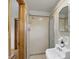 Neutral bathroom with glass shower, retro sink and hardware and tiled floor at 4614 Thornleigh Dr, Indianapolis, IN 46226