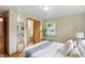 A bright bedroom with a full sized mirror and easy access to a private bathroom at 4614 Thornleigh Dr, Indianapolis, IN 46226