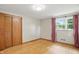 Bedroom features hardwood floors, a closet, window with views and pink drapes at 4614 Thornleigh Dr, Indianapolis, IN 46226