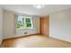 Bedroom features hardwood floors, a closet, window with views and beige drapes at 4614 Thornleigh Dr, Indianapolis, IN 46226