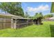 Large yard with two chicken coops on a sunny day at 4614 Thornleigh Dr, Indianapolis, IN 46226