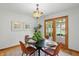 This dining room features a modern light fixture, table, and a view through the patio doors at 4614 Thornleigh Dr, Indianapolis, IN 46226