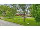 A single-story red brick home with a green lawn and mature trees at 4614 Thornleigh Dr, Indianapolis, IN 46226
