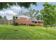 Beautiful brick home with a well-kept lawn, complemented by vibrant flower beds and mature trees at 4614 Thornleigh Dr, Indianapolis, IN 46226