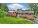 Charming brick home featuring lush landscaping and a well-manicured lawn at 4614 Thornleigh Dr, Indianapolis, IN 46226