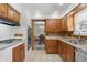 Updated kitchen with wood cabinets, stainless appliances, and tile floor at 4614 Thornleigh Dr, Indianapolis, IN 46226