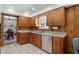 Functional kitchen with wood cabinets and stainless steel dishwasher at 4614 Thornleigh Dr, Indianapolis, IN 46226