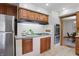 Cozy kitchen with stainless steel refrigerator, granite countertops, and modern appliances at 4614 Thornleigh Dr, Indianapolis, IN 46226