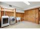 Bright laundry room offers a convenient utility sink and wooden cabinets for storage space at 4614 Thornleigh Dr, Indianapolis, IN 46226
