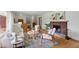 Bright and airy living room featuring hardwood floors, a brick fireplace, and modern, comfortable furnishings at 4614 Thornleigh Dr, Indianapolis, IN 46226
