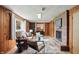 Inviting living room showcasing wood paneling, comfortable seating, and a brick fireplace with mounted TV at 4614 Thornleigh Dr, Indianapolis, IN 46226