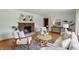 Elegant living room with a brick fireplace, hardwood floors, comfortable seating, and sophisticated decor at 4614 Thornleigh Dr, Indianapolis, IN 46226