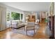 Bright living room with fireplace, hardwood floors, and large windows at 4614 Thornleigh Dr, Indianapolis, IN 46226