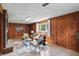 Bright living room features wood paneling, contemporary decor, and a brick fireplace, creating a welcoming space at 4614 Thornleigh Dr, Indianapolis, IN 46226