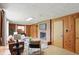 Spacious living room with wood walls, a brick fireplace, and well-placed seating, offering a comfortable atmosphere at 4614 Thornleigh Dr, Indianapolis, IN 46226