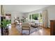Cozy living room with hardwood floors, comfortable seating, a large window, and tasteful decor at 4614 Thornleigh Dr, Indianapolis, IN 46226