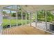Inviting screened porch with wood floors and views of the landscaped backyard and exterior patio at 4614 Thornleigh Dr, Indianapolis, IN 46226