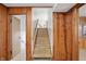Stairway with wood paneling going to upper level with an open door to the left at 4614 Thornleigh Dr, Indianapolis, IN 46226