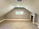 Attic space with carpet, window, and storage niche at 4814 E New York St, Indianapolis, IN 46201