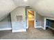 View of the attic featuring light gray walls, carpeting, air vent, and open access to the next room at 4814 E New York St, Indianapolis, IN 46201