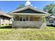 Charming home featuring a stone front porch, yellow front door, and inviting curb appeal at 4814 E New York St, Indianapolis, IN 46201