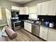 Updated kitchen featuring stainless steel appliances, modern cabinets, and sleek countertops at 4814 E New York St, Indianapolis, IN 46201