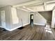 Spacious living room features fresh paint, new flooring, and a staircase at 4814 E New York St, Indianapolis, IN 46201
