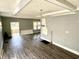 Large living area featuring new floors, gray paint, and an entrance to the home's porch at 4814 E New York St, Indianapolis, IN 46201