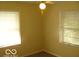 Bright bedroom featuring a ceiling fan and dual windows for natural light at 4830 Wentworth Blvd, Indianapolis, IN 46201