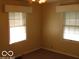 Inviting bedroom with neutral decor and windows that filter in natural light at 4830 Wentworth Blvd, Indianapolis, IN 46201