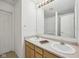 Bright bathroom featuring a double sink vanity and a well-lit mirror at 513 Sun Catcher Dr, Avon, IN 46123