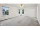 Spacious bedroom with plush carpet, multiple windows, and a ceiling fan at 513 Sun Catcher Dr, Avon, IN 46123