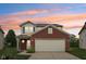 Charming two-story home with a brick facade, inviting entrance, and attached two-car garage at 513 Sun Catcher Dr, Avon, IN 46123