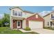 Charming front exterior with brick accents and an attached two-car garage at 513 Sun Catcher Dr, Avon, IN 46123
