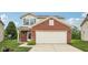 Classic front exterior featuring brick details, a garage, and tidy landscaping at 513 Sun Catcher Dr, Avon, IN 46123