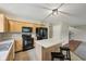 Functional kitchen with light wood cabinets, island and black appliances at 513 Sun Catcher Dr, Avon, IN 46123