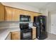 Kitchen includes wooden cabinets and modern black appliances at 513 Sun Catcher Dr, Avon, IN 46123